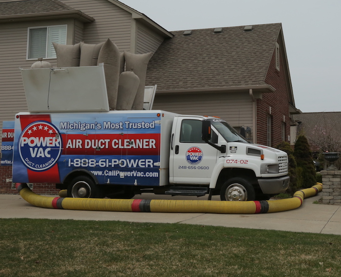 A Power Vac Air duct cleaning truck outside a house during a cleaning